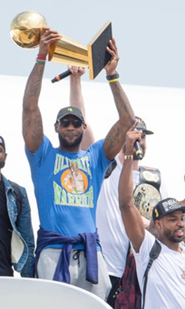 Off the plane but still sky-high, LeBron brings title home